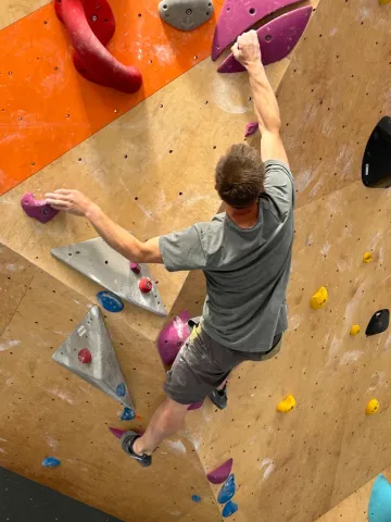 A climber on the bouldering wall at ChalkUp! in Somerset