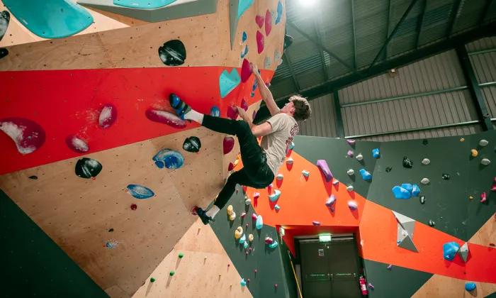 Climber on overhang section of dawn wall at ChalkUp bouldering