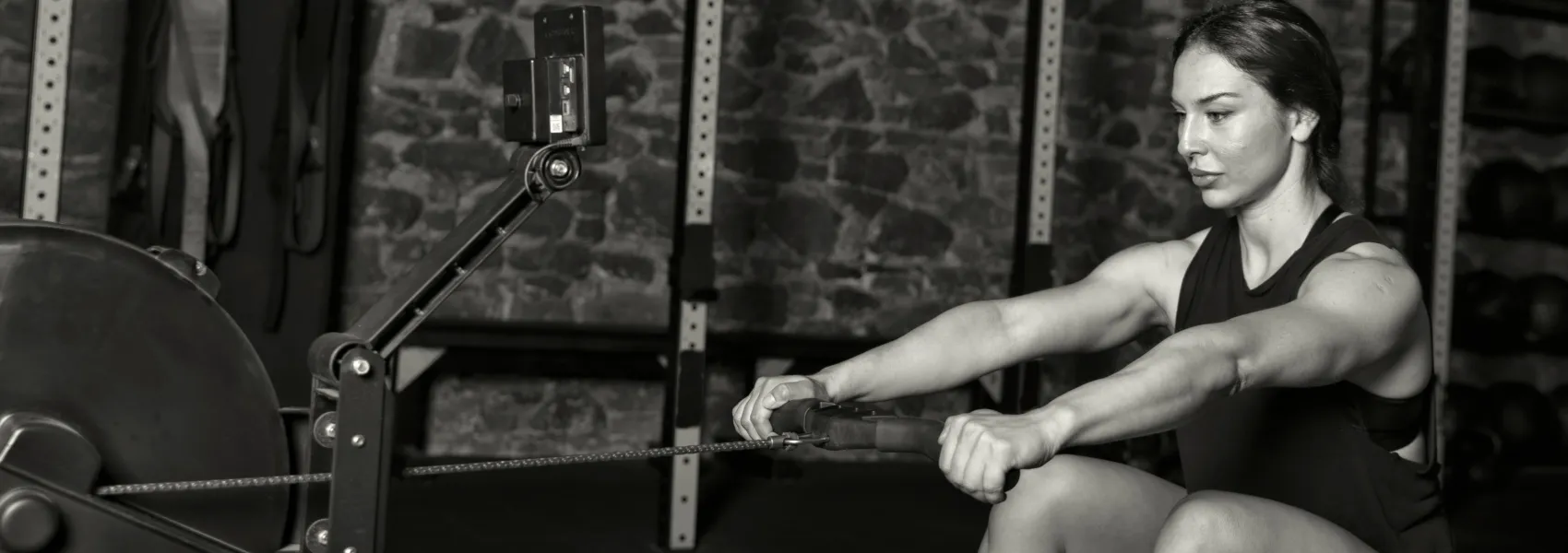 Female athlete rows on a Concept 2 row erg