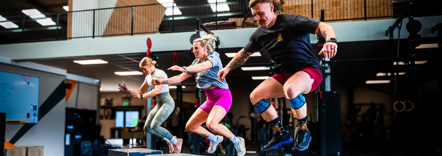 CrossFit members jump onto wooden boxes